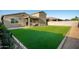 Enjoy the backyard with artificial turf, patio, covered outdoor space, and convenient hot tub at 17813 W Pinnacle Vista Dr, Surprise, AZ 85387