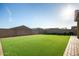 Spacious backyard with artificial turf, offering a low-maintenance outdoor living space at 17813 W Pinnacle Vista Dr, Surprise, AZ 85387