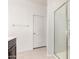 Modern bathroom featuring a glass shower, a tile floor, and a white door at 17813 W Pinnacle Vista Dr, Surprise, AZ 85387
