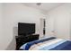 Bedroom featuring a TV mounted above a dresser, with striped bedding at 17813 W Pinnacle Vista Dr, Surprise, AZ 85387
