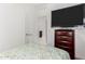 Bedroom with a TV mounted above a dresser, with bed with stylish patterned bedding at 17813 W Pinnacle Vista Dr, Surprise, AZ 85387