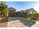 Charming single-story home featuring a three-car garage and brick driveway at 17813 W Pinnacle Vista Dr, Surprise, AZ 85387