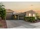 Inviting home showcasing a spacious driveway and beautifully landscaped front yard at 17813 W Pinnacle Vista Dr, Surprise, AZ 85387