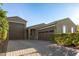 Charming single-story home featuring a three-car garage and brick driveway at 17813 W Pinnacle Vista Dr, Surprise, AZ 85387
