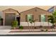 Charming single-story home featuring a well-manicured front yard and a two-car garage at 17813 W Pinnacle Vista Dr, Surprise, AZ 85387