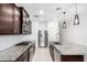 Well-equipped kitchen featuring granite counters, stainless steel appliances, and ample cabinet space at 17813 W Pinnacle Vista Dr, Surprise, AZ 85387