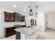 Modern kitchen with granite countertops, stainless steel appliances, and stylish pendant lighting at 17813 W Pinnacle Vista Dr, Surprise, AZ 85387