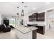 Bright kitchen featuring granite countertops, stainless steel appliances, and modern pendant lighting at 17813 W Pinnacle Vista Dr, Surprise, AZ 85387