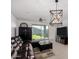 Bright living room featuring a brown leather sofa, entertainment center, and backyard views at 17813 W Pinnacle Vista Dr, Surprise, AZ 85387