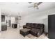 Open-concept space with living room and kitchen featuring modern appliances and a granite island at 17813 W Pinnacle Vista Dr, Surprise, AZ 85387