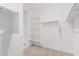 Spacious walk-in closet featuring ample shelving and rods for organized storage at 17813 W Pinnacle Vista Dr, Surprise, AZ 85387