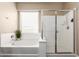 This bathroom features a shower and a soaking tub at 19887 N Herbert Ave, Maricopa, AZ 85138