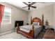 Comfortable bedroom with neutral walls, plush carpet, a window, and a four-poster bed at 19887 N Herbert Ave, Maricopa, AZ 85138