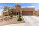 Charming single-story home with a well-manicured front yard and a two-car garage at 19887 N Herbert Ave, Maricopa, AZ 85138
