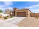 Beautiful single-story home with a two-car garage, desert landscaping, and a cozy porch at 19887 N Herbert Ave, Maricopa, AZ 85138