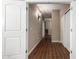 This hallway has wood floors and doors on both sides at 19887 N Herbert Ave, Maricopa, AZ 85138