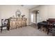Cozy living room area with stylish cabinet and open doorway at 19887 N Herbert Ave, Maricopa, AZ 85138