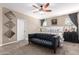 A spacious main bedroom boasts neutral walls, plush carpeting, and a comfortable king-size bed at 19887 N Herbert Ave, Maricopa, AZ 85138