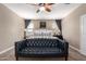 A spacious main bedroom boasts neutral walls, plush carpeting, and a comfortable king-size bed at 19887 N Herbert Ave, Maricopa, AZ 85138