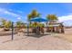 Community playground with swings, rock climbing feature, and covered picnic area for residents at 19887 N Herbert Ave, Maricopa, AZ 85138