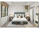 Stylish bedroom with a padded headboard, natural light, and sleek modern decor at 20309 W Roma Ave, Buckeye, AZ 85396