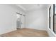 Bedroom with wood-look floors, tray ceiling, a barn door leading to a glassed-in shower at 20302 W Turney Ave, Buckeye, AZ 85396
