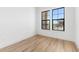 Bedroom with wood-look flooring, neutral walls, and two large windows with neighborhood views at 20302 W Turney Ave, Buckeye, AZ 85396