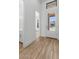 Bright entryway with wood floors, white walls, and a view of the front yard through a glass door at 20302 W Turney Ave, Buckeye, AZ 85396