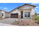 Beautiful single-Gathering home showcasing stone accents, desert landscaping and a two-car garage at 20302 W Turney Ave, Buckeye, AZ 85396