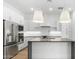 Stylish kitchen showcasing stainless steel appliances, white cabinets, and an island with dark counter top at 20302 W Turney Ave, Buckeye, AZ 85396