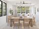 Elegant dining area featuring a wooden table, chairs, and a cozy sitting area with natural light at 20309 W Roma Ave, Buckeye, AZ 85396