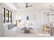 Bright living room with comfortable seating, stylish decor, and ample natural light from large windows at 20309 W Roma Ave, Buckeye, AZ 85396