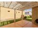 Backyard patio covered by a pergola with string lights and featuring artificial grass at 20733 W Alsap Rd, Buckeye, AZ 85396