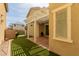 Inviting backyard with a covered patio, string lights, turf, and a neutral-toned two-story house for outdoor living at 20733 W Alsap Rd, Buckeye, AZ 85396