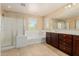 This bathroom features a tub, shower and a large mirror at 20733 W Alsap Rd, Buckeye, AZ 85396