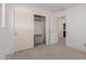 Bright bedroom featuring a closet with sliding doors and built-in shelving for storage at 20733 W Alsap Rd, Buckeye, AZ 85396