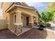 Inviting home featuring a cozy front porch with stone supports, enhancing the property's curb appeal at 20733 W Alsap Rd, Buckeye, AZ 85396