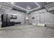 Well-organized garage featuring epoxy sealed floors, shelving, and overhead lighting, offering ample storage space at 20733 W Alsap Rd, Buckeye, AZ 85396