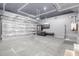 Spacious garage with updated features, including storage racks, sleek epoxy flooring, and high-efficiency door at 20733 W Alsap Rd, Buckeye, AZ 85396