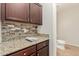 A secondary kitchen view shows granite countertops, mosaic backsplash and wood cabinets at 20733 W Alsap Rd, Buckeye, AZ 85396