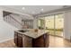 Kitchen island with stainless steel sink and granite countertop. Leads to the backyard and has great lighting at 20733 W Alsap Rd, Buckeye, AZ 85396