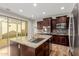 Modern kitchen showcasing a center island, stainless steel appliances, and a view of the backyard at 20733 W Alsap Rd, Buckeye, AZ 85396