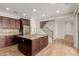 Spacious kitchen features a central island, wood cabinets, granite countertops and stainless steel appliances at 20733 W Alsap Rd, Buckeye, AZ 85396