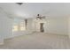 Large, carpeted, main bedroom features large windows, ceiling fan and bright, neutral paint at 20733 W Alsap Rd, Buckeye, AZ 85396