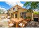 Cozy backyard with a wood dining table, bbq, and multiple seating areas at 21840 N 41St St, Phoenix, AZ 85050