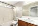 Standard bathroom with a wood vanity, large mirror, and tub with white tile surround at 21840 N 41St St, Phoenix, AZ 85050