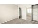 Empty bedroom with a sliding door closet, carpeting, and neutral walls at 21840 N 41St St, Phoenix, AZ 85050