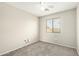 Simple carpeted bedroom features natural lighting and neutral walls at 21840 N 41St St, Phoenix, AZ 85050