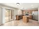 Kitchen with stainless steel appliances, wood cabinets, a center island, and a sliding glass door at 21840 N 41St St, Phoenix, AZ 85050