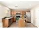 A functional kitchen featuring wood cabinets, stainless steel appliances, and a center island at 21840 N 41St St, Phoenix, AZ 85050